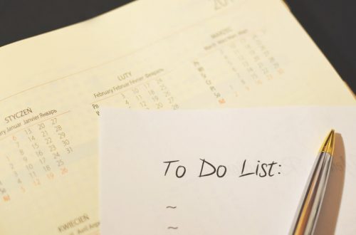 Close-up of a calendar and to-do list on a desk, emphasizing planning and organization.